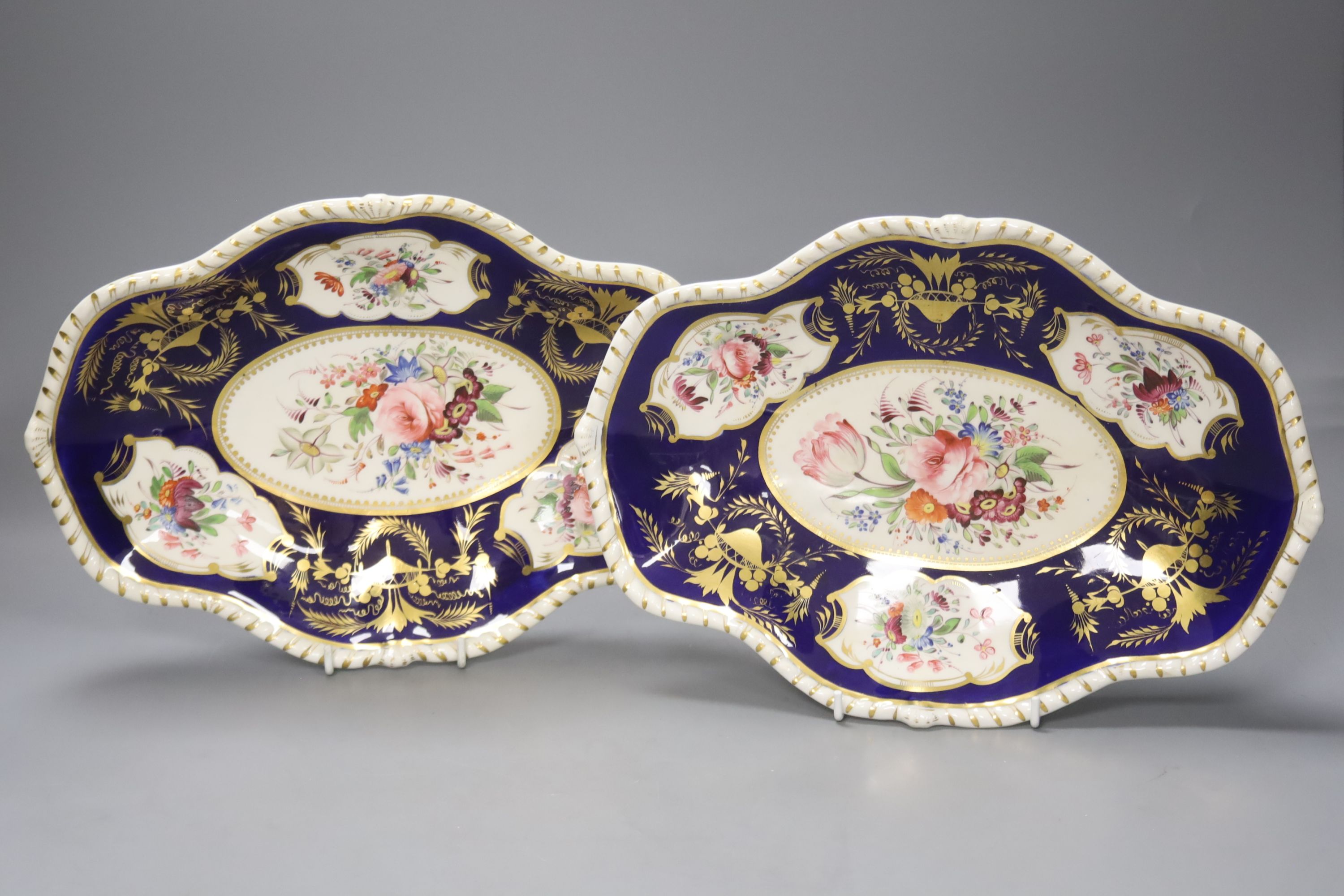 A pair of Crown Derby oval dishes, painted with four floral panels, c.1825, length 31cm